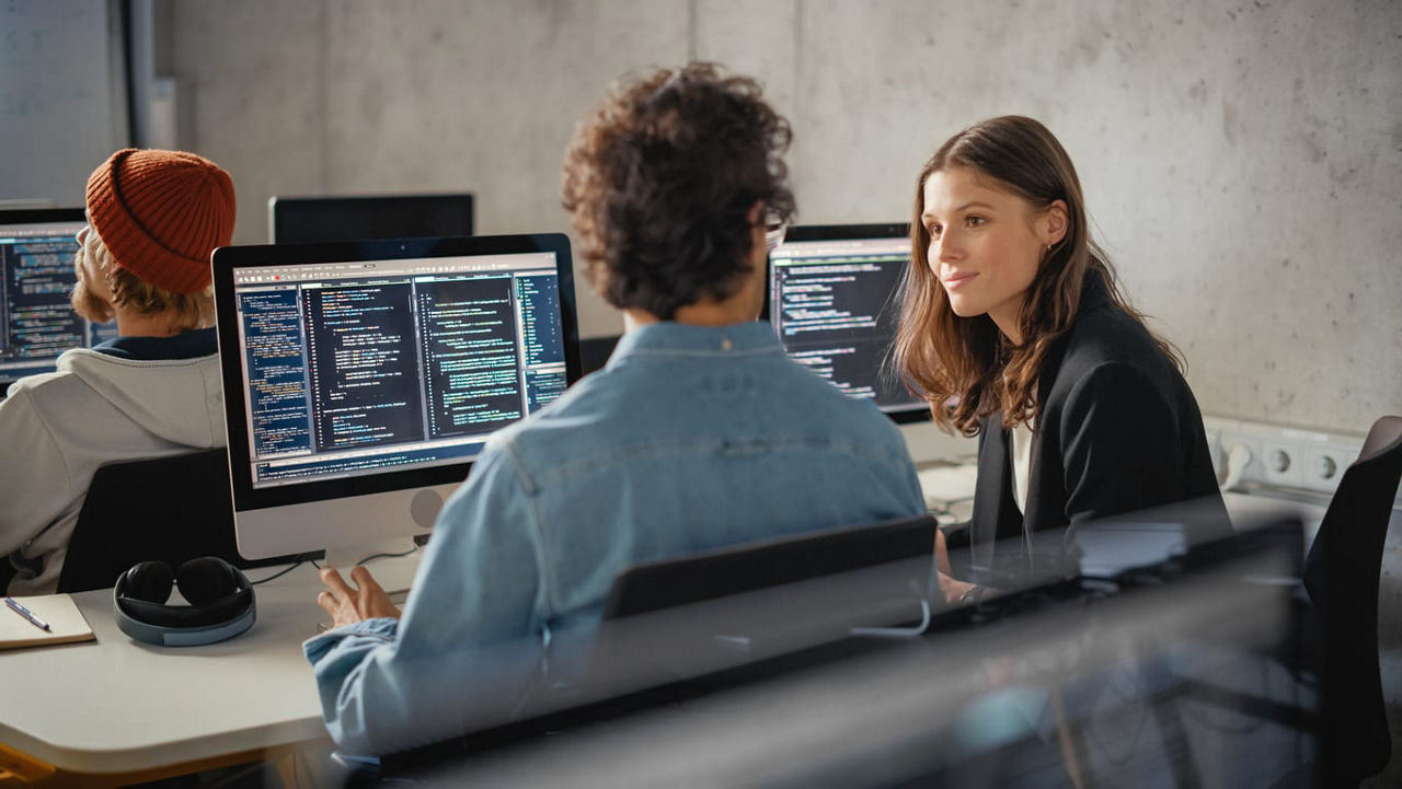 A group of people working on computers in an office.