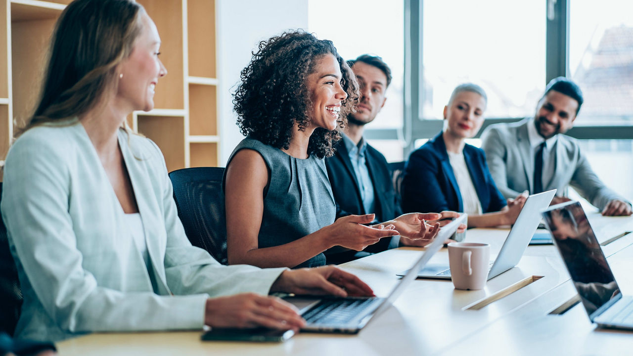 A group of business people sitting around a conference table.