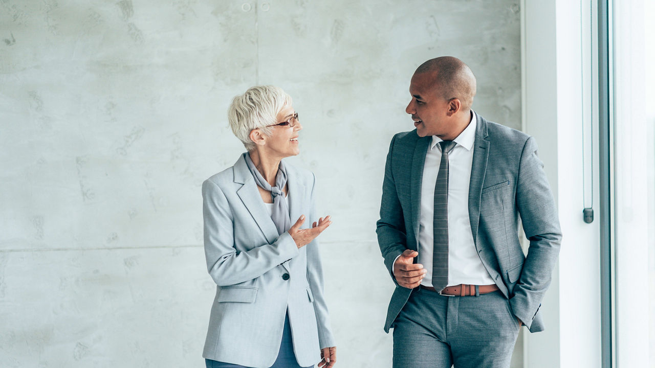 Two business people talking in an office.