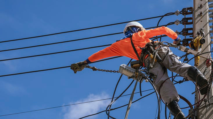 A man is working on a power line.