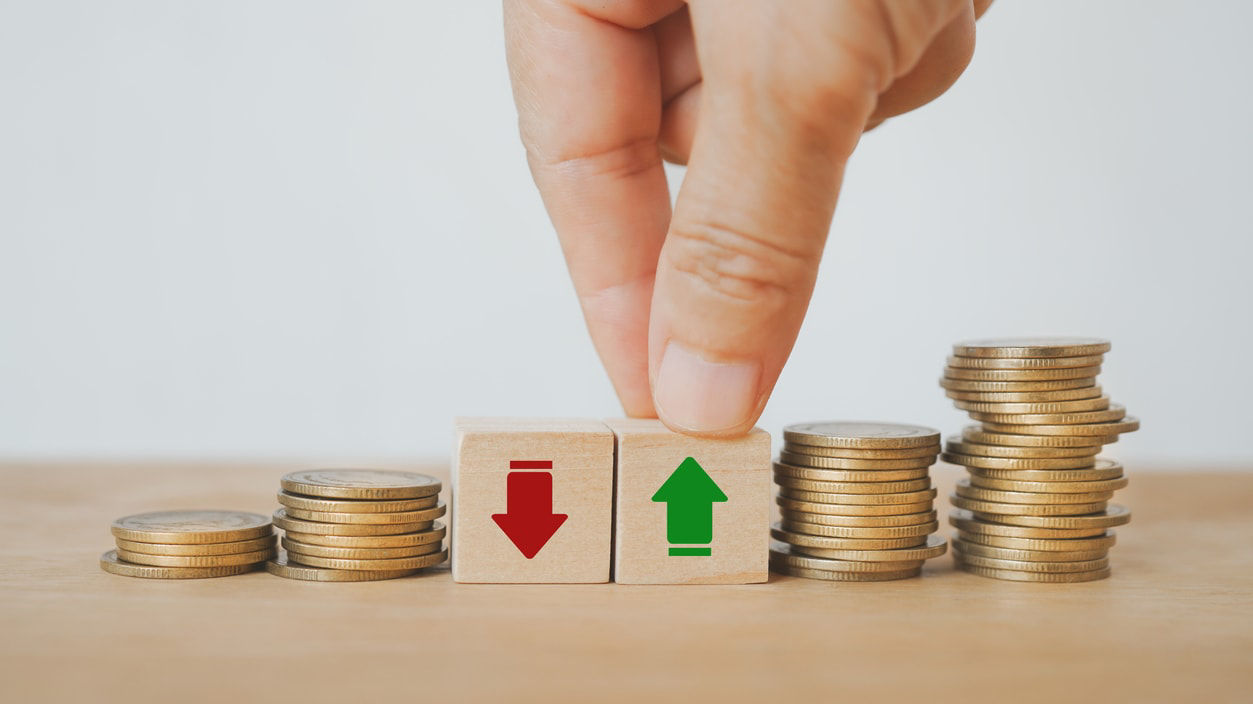 A hand is pointing to a stack of coins with an arrow pointing up.