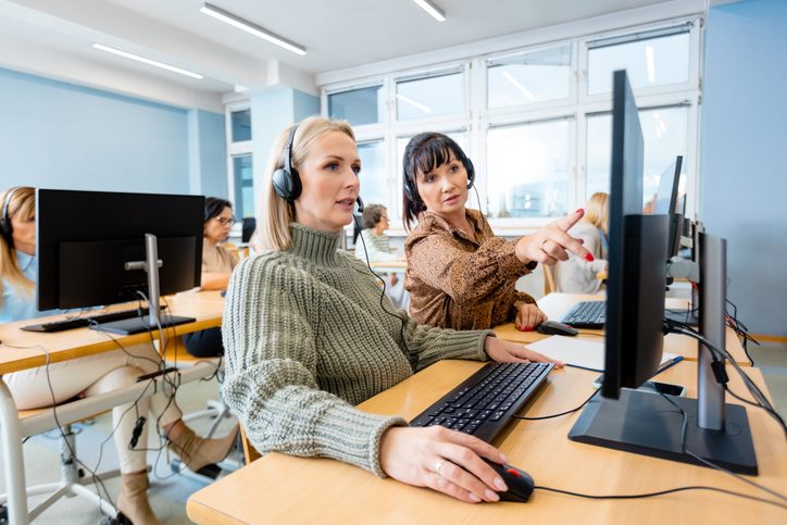 women with headphones at computer