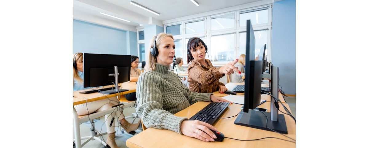 women with headphones at computer