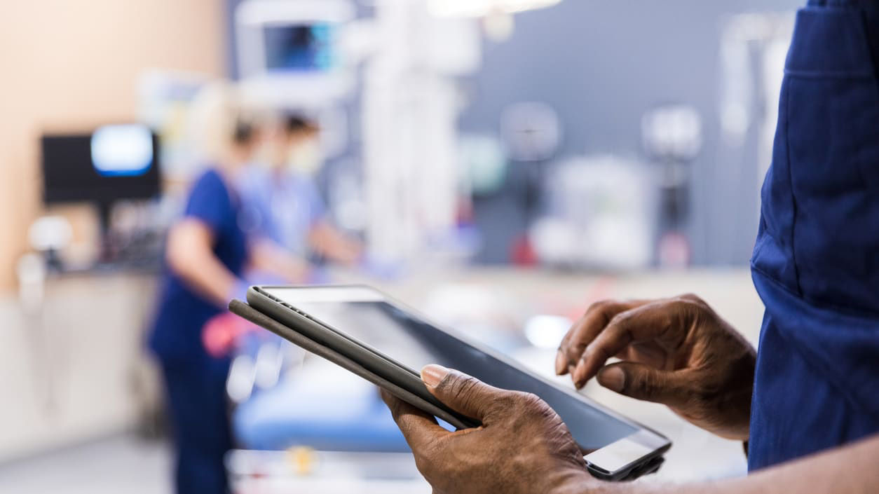 A nurse is using a tablet in a hospital.