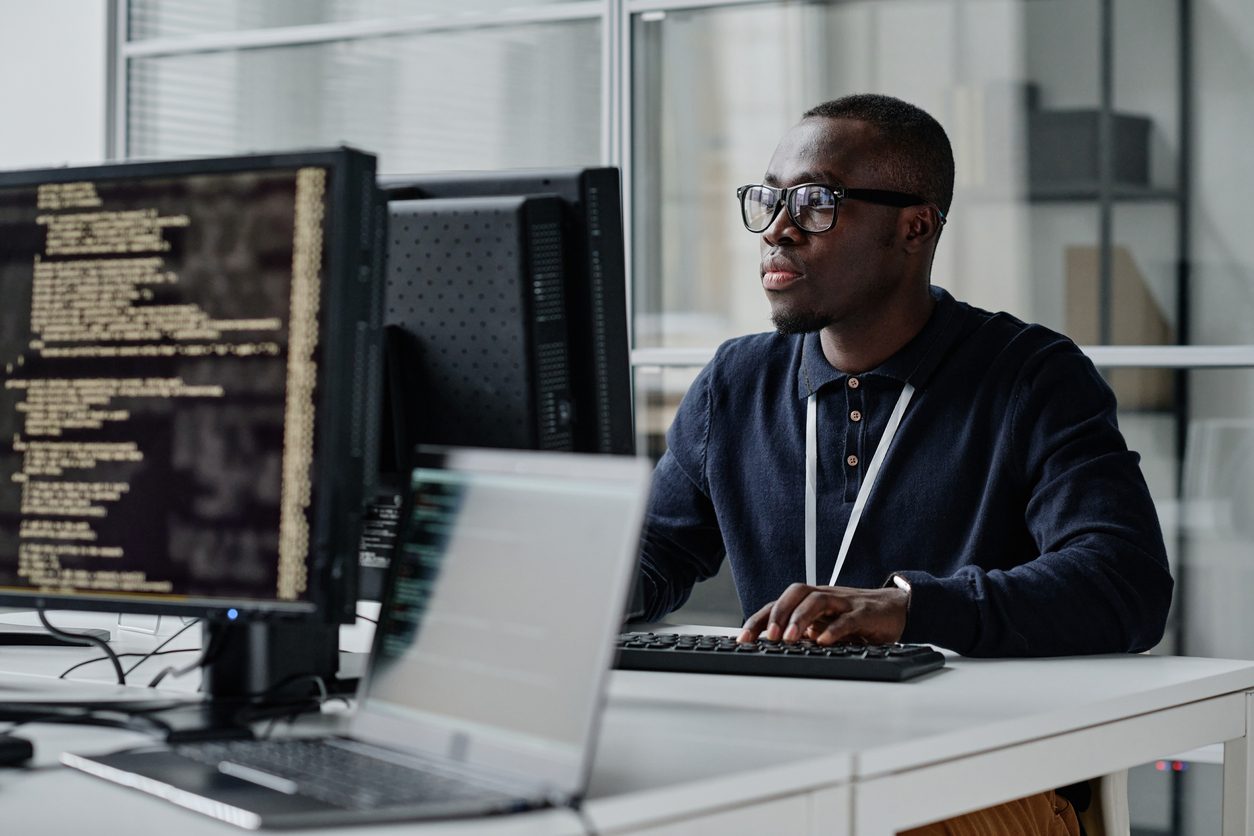 black man sits at computer