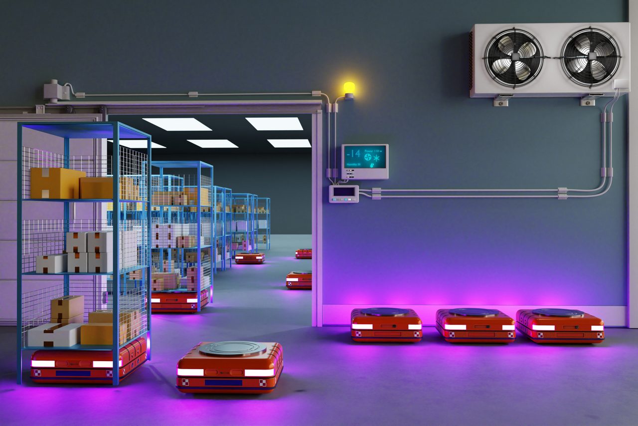 An automated warehouse illuminated by purple and white lighting, showcasing several red mobile robots carrying boxes. The robots are navigating through aisles lined with tall metal storage racks filled with various goods. There's a climate control system on the wall, and digital thermometers indicating the current temperature.