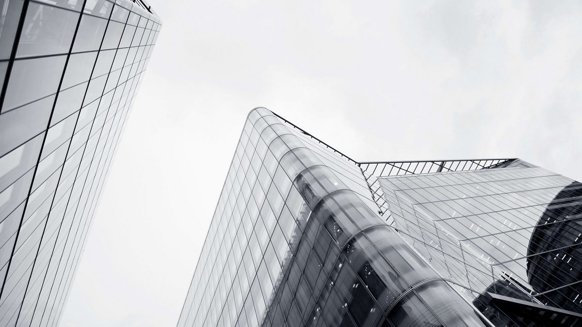 A black and white photo of tall buildings in london.