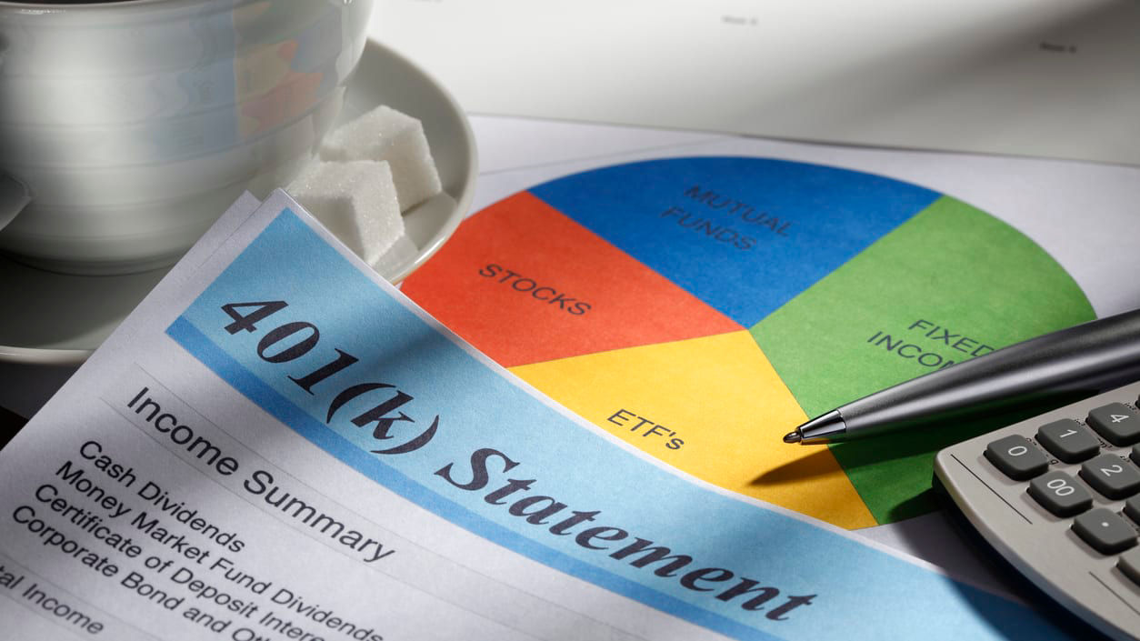 A cup of coffee and a piece of paper with a pie chart on it.