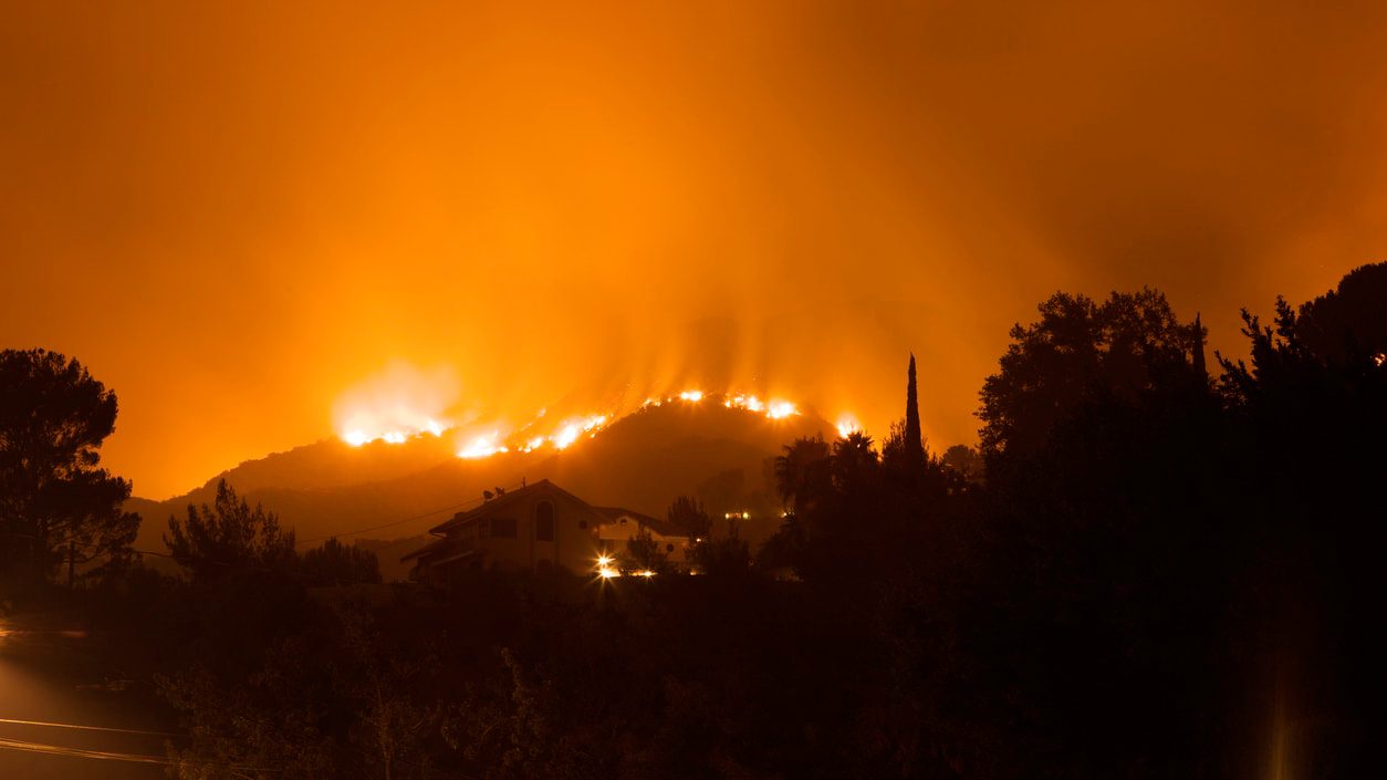 A fire burns on a hillside in california.