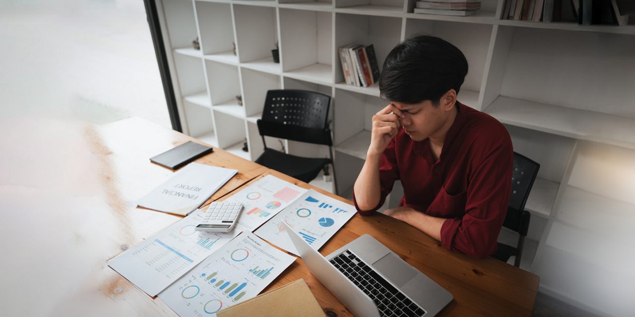 asian american workers stressed at desk