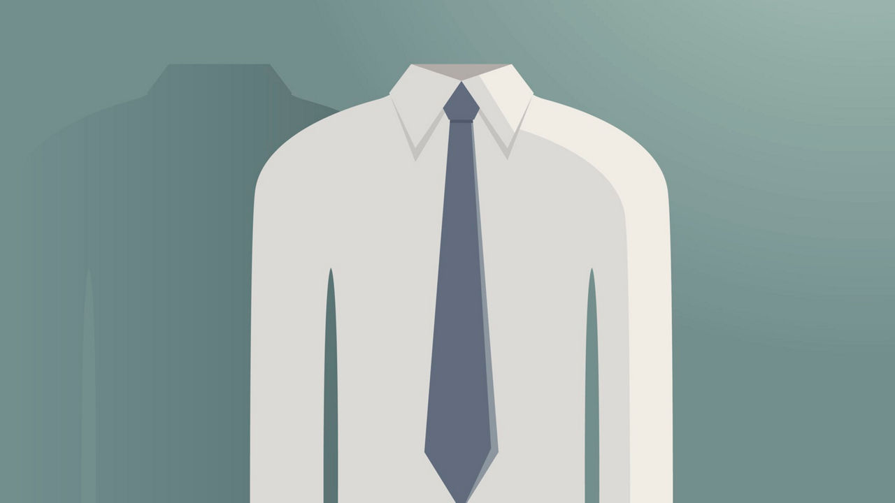 A man wearing glasses and a tie.