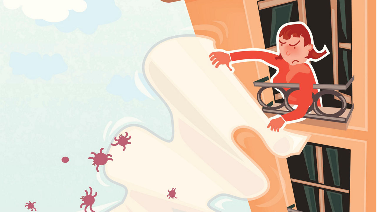 A woman is sitting on a window sill with a piece of paper in her hand.