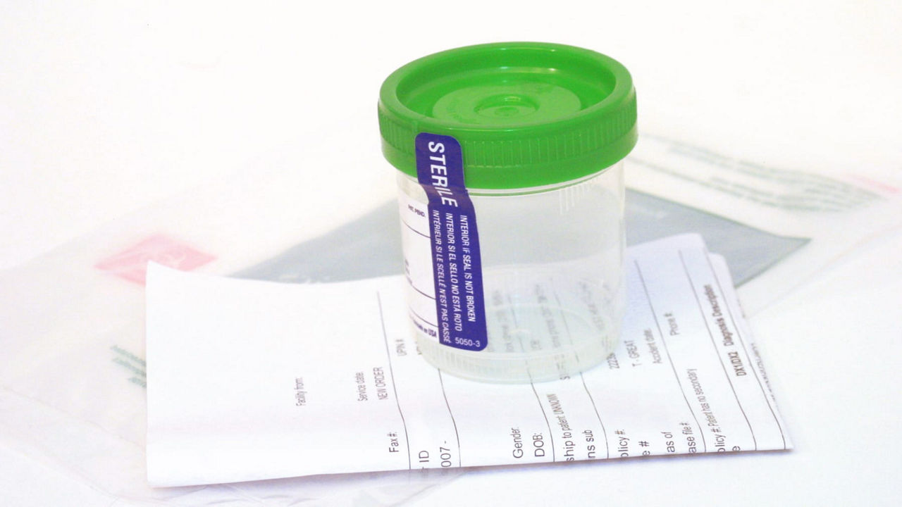 A green syringe sitting on top of a piece of paper.
