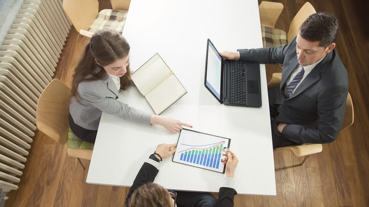 A group of business people working at a table.