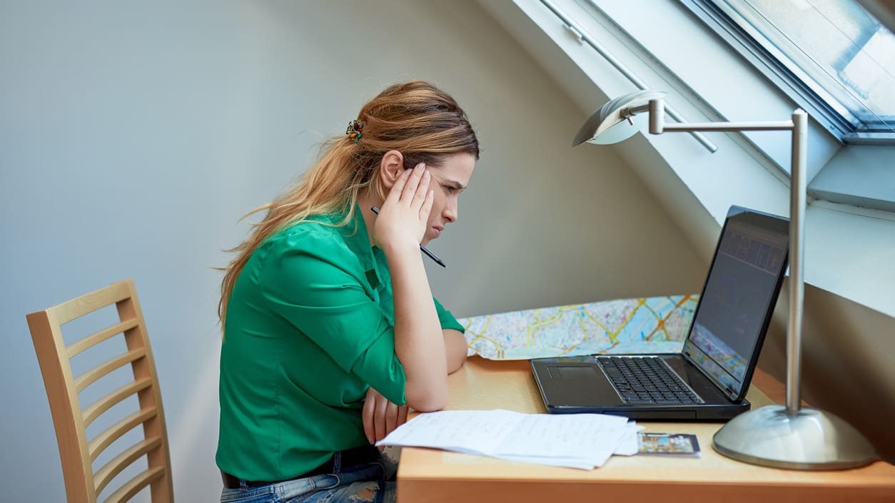 A woman sitting at a desk with a laptop.