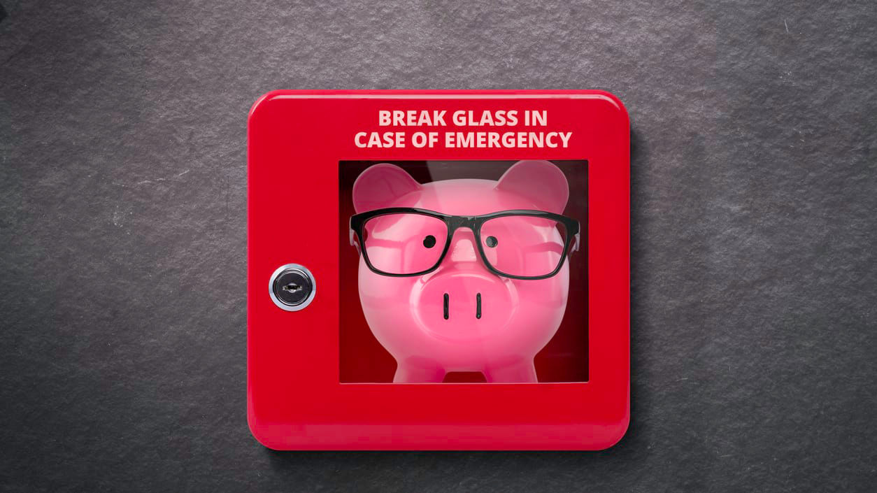 A piggy bank with glasses that says break glass in case of emergency.