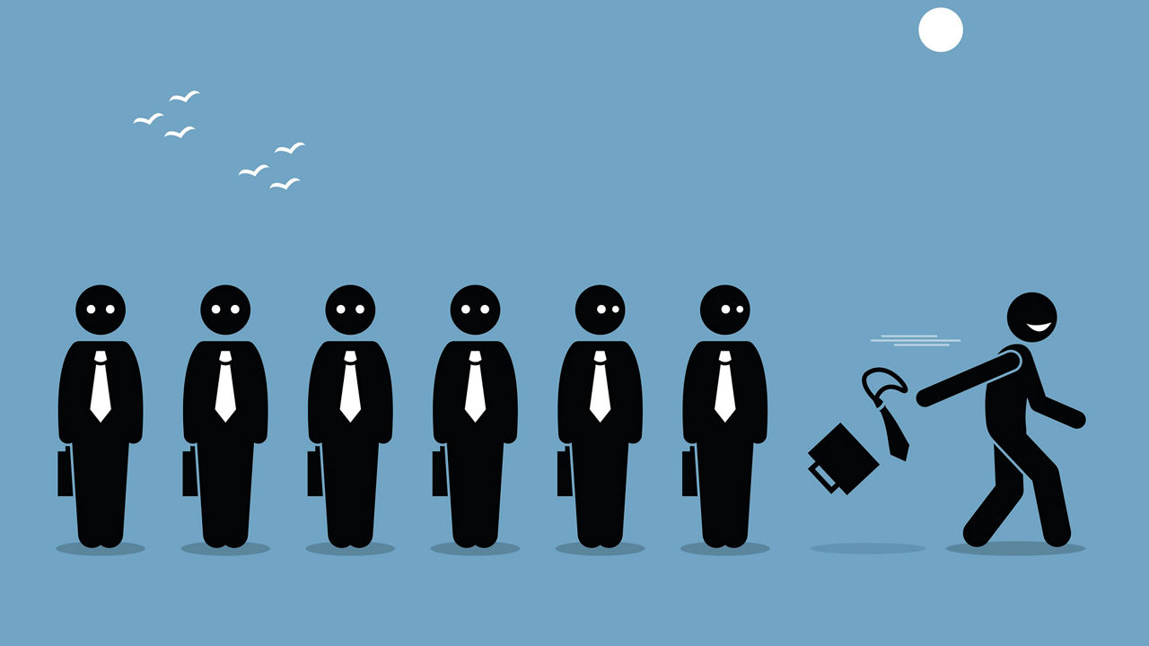 A group of people walking in a line with a briefcase.