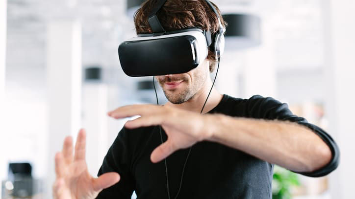 A man wearing a vr headset in an office.