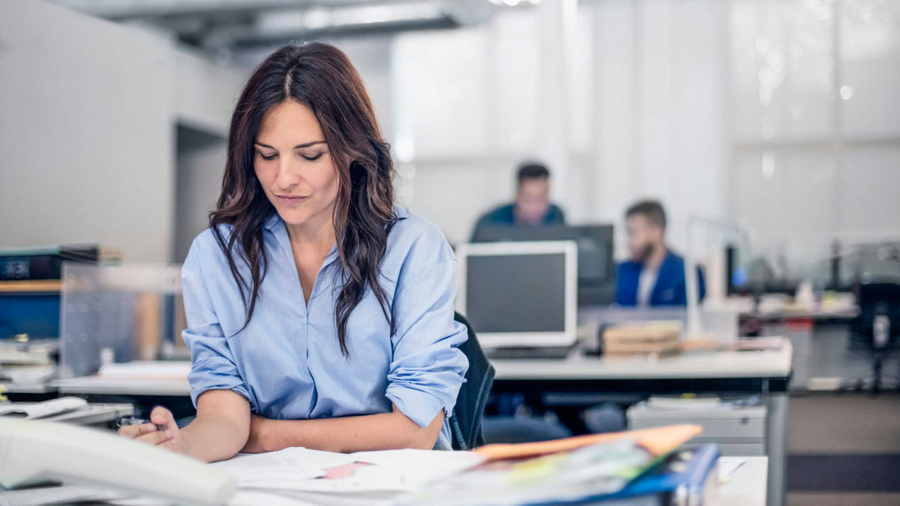 A woman working at a desk in an office.