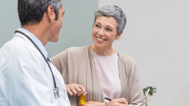 A doctor talking to a patient in a doctor's office.