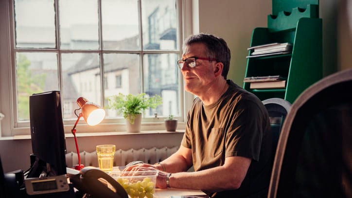 A man sitting at his desk working on his computer.