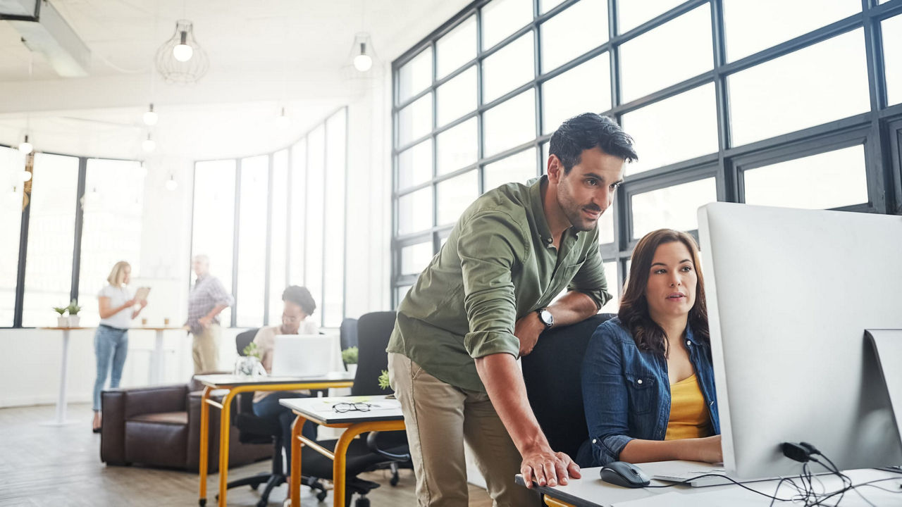 A group of people working on computers in an office.