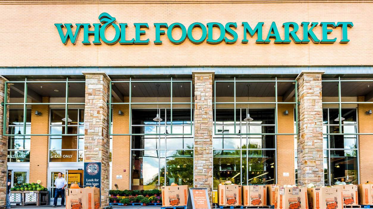 A whole foods market with boxes in front of it.