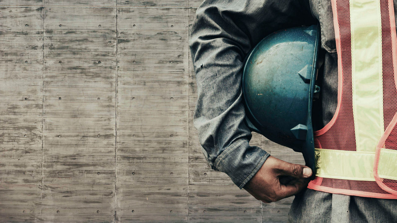 A construction worker wearing a hard hat and safety vest.