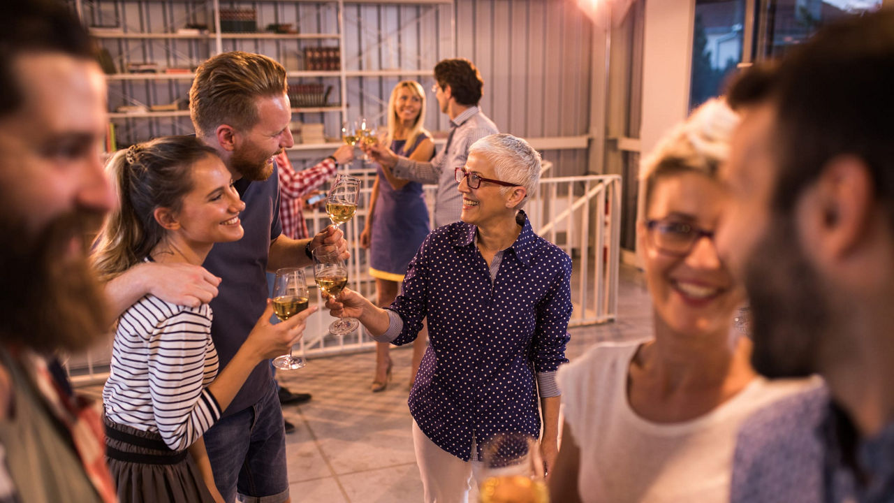 A group of people drinking wine at a party.