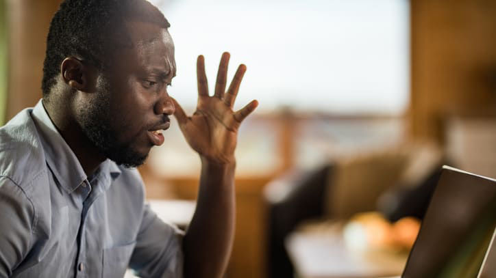 A man looking at a laptop.