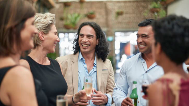 A group of people drinking wine at a party.