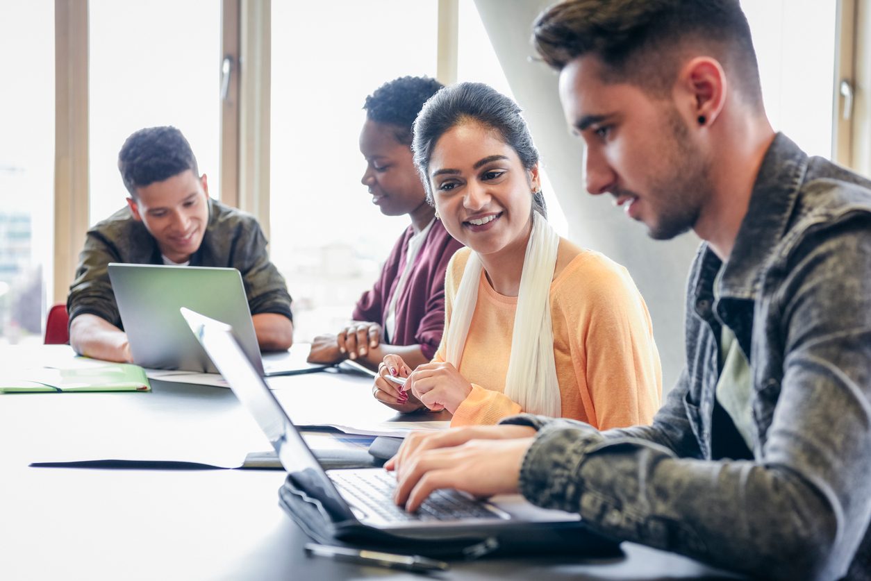 Students working on computer in classroom.