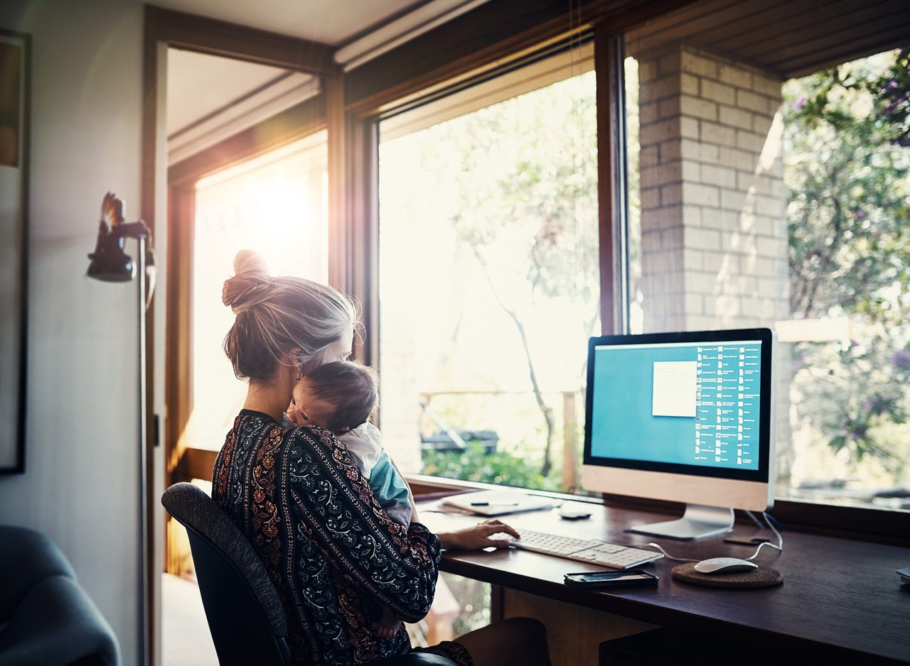 working mother holding her infant