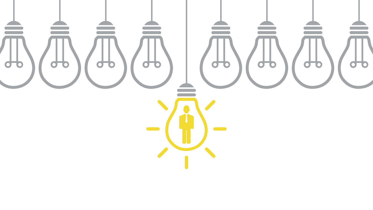 A group of light bulbs with a person in the middle.