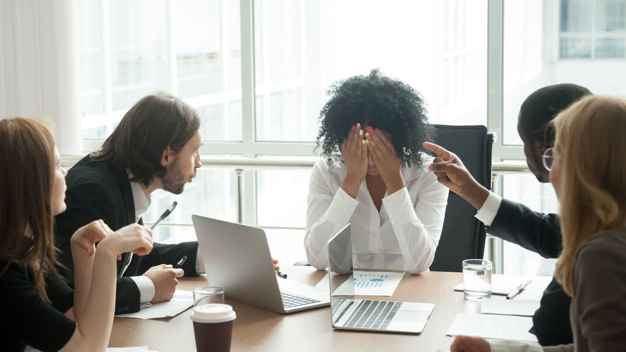 A group of business people sitting around a conference table.