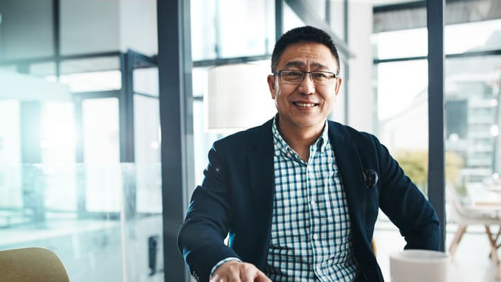Businessman sitting at a table with a cup of coffee.