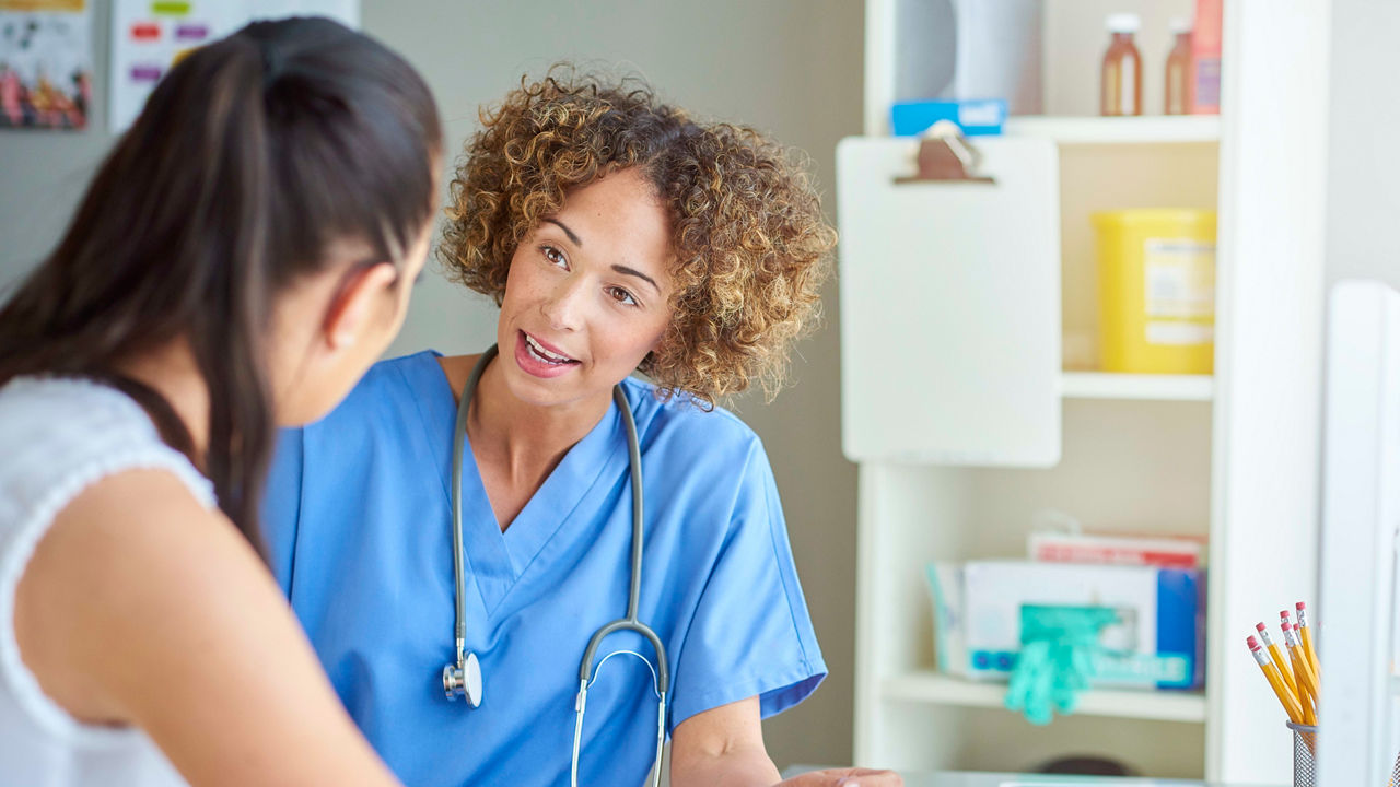 A female doctor talking to a female patient.