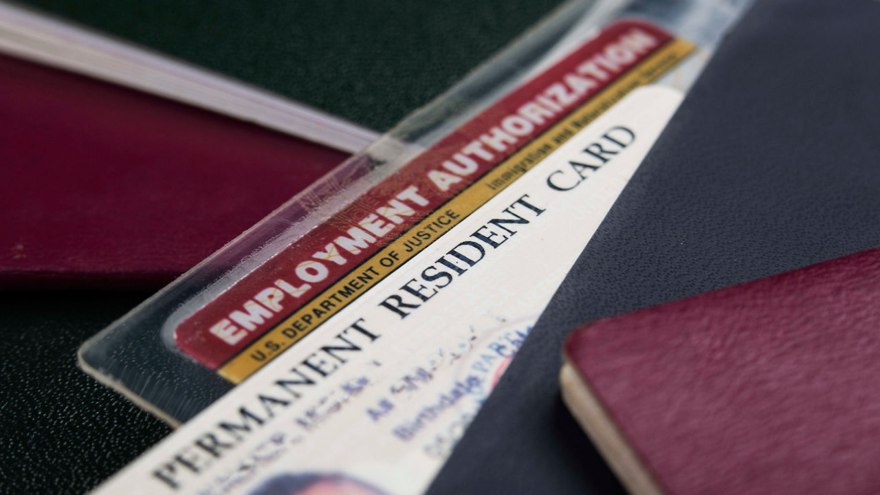 Id cards and passports on a table.