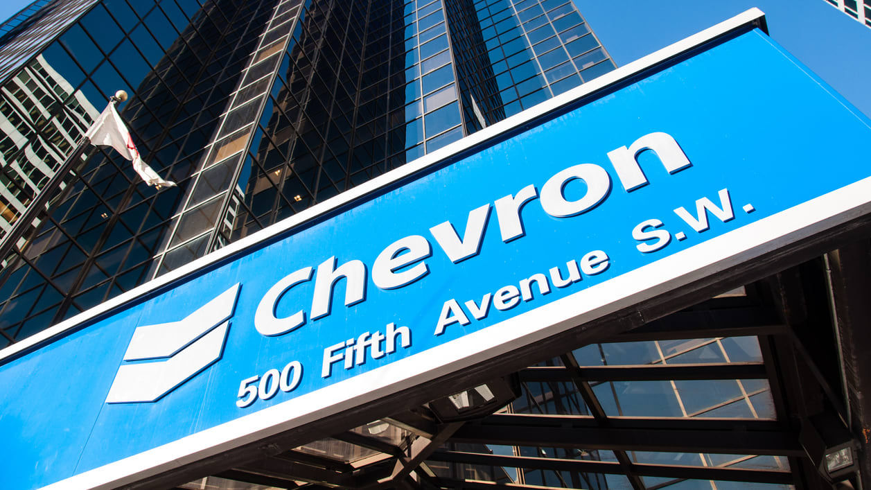 A blue sign with chevron on it.