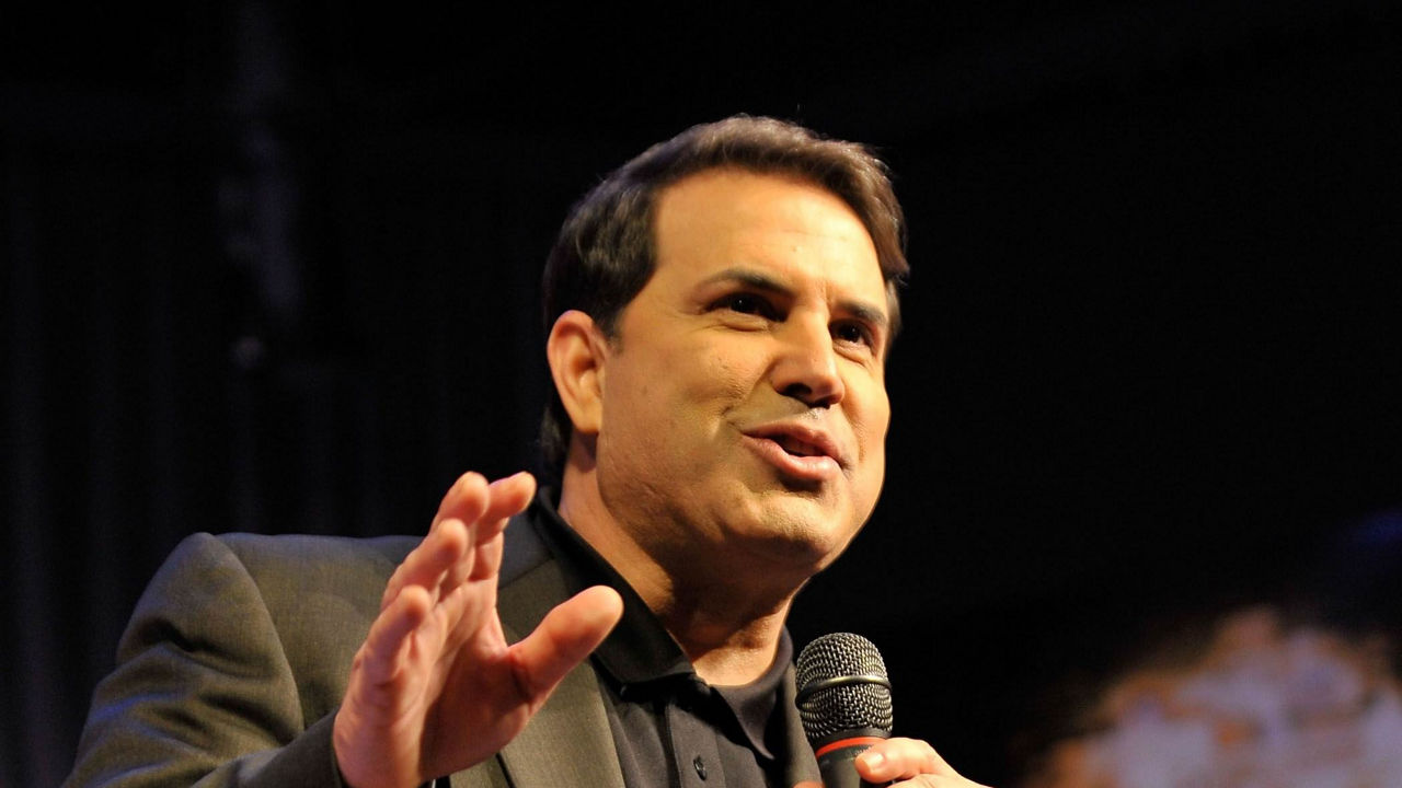 A man is speaking into a microphone.