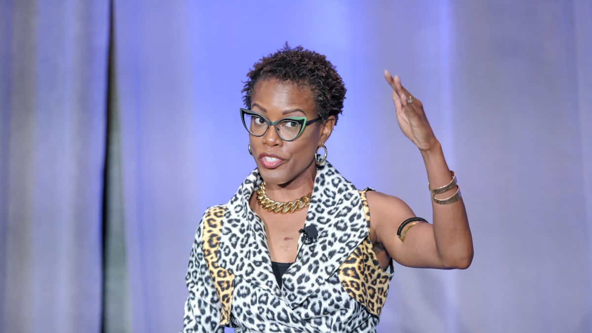 A woman giving a speech on stage.