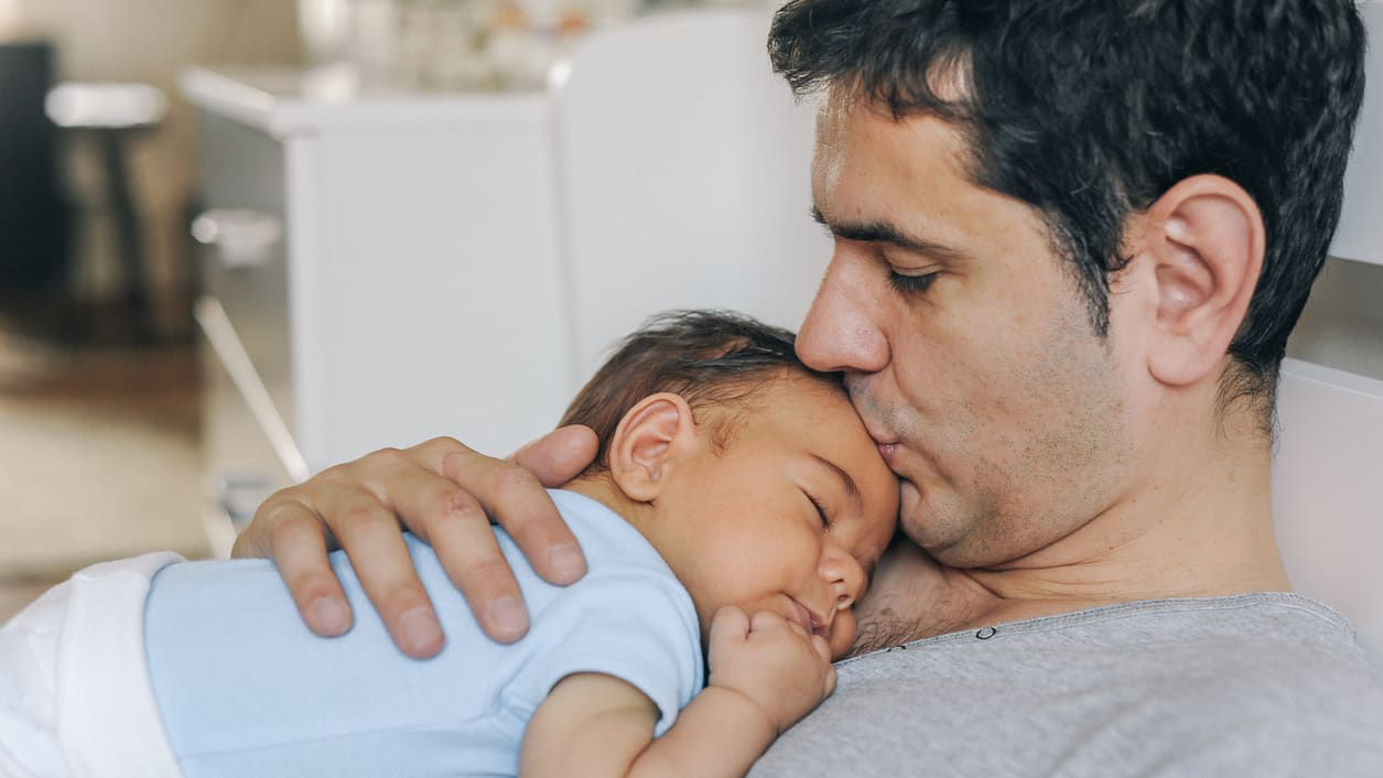 Dad holding newborn