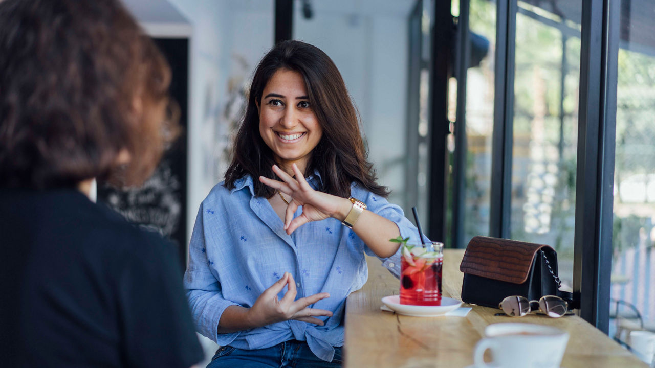 Two women sitting at a table in a coffee shop.