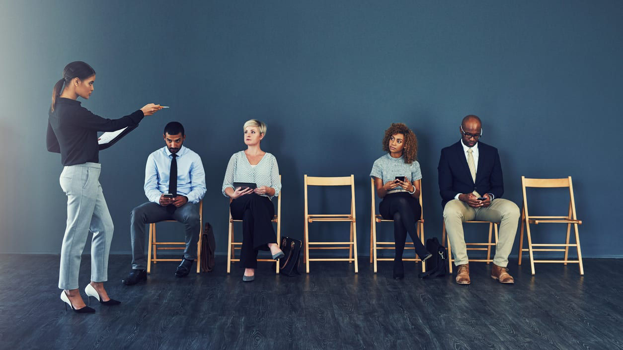 A group of people sitting in chairs in a room.