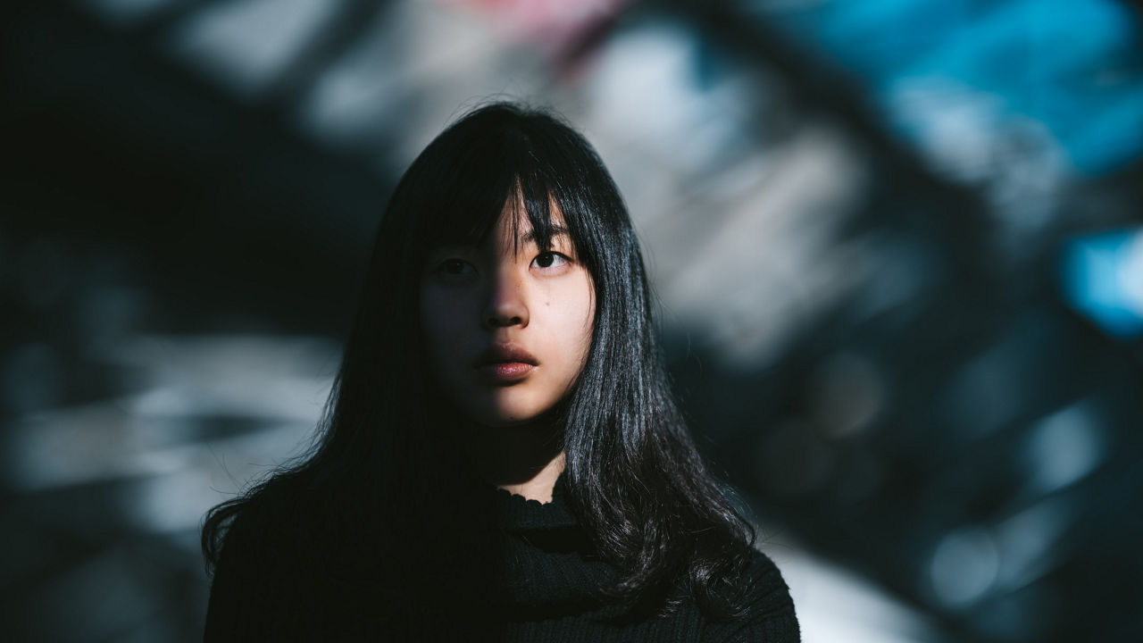 A young woman in a black sweater.
