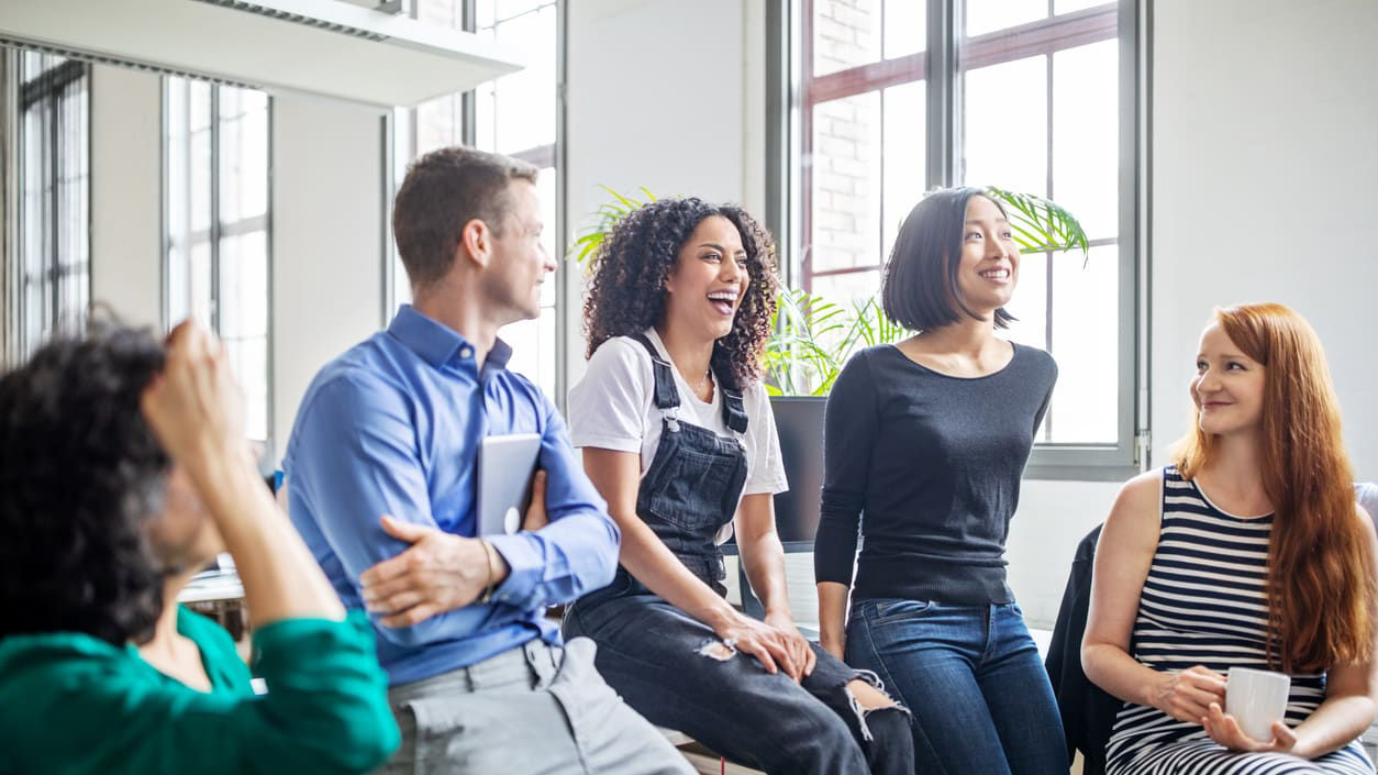 A group of people sitting together in an office.