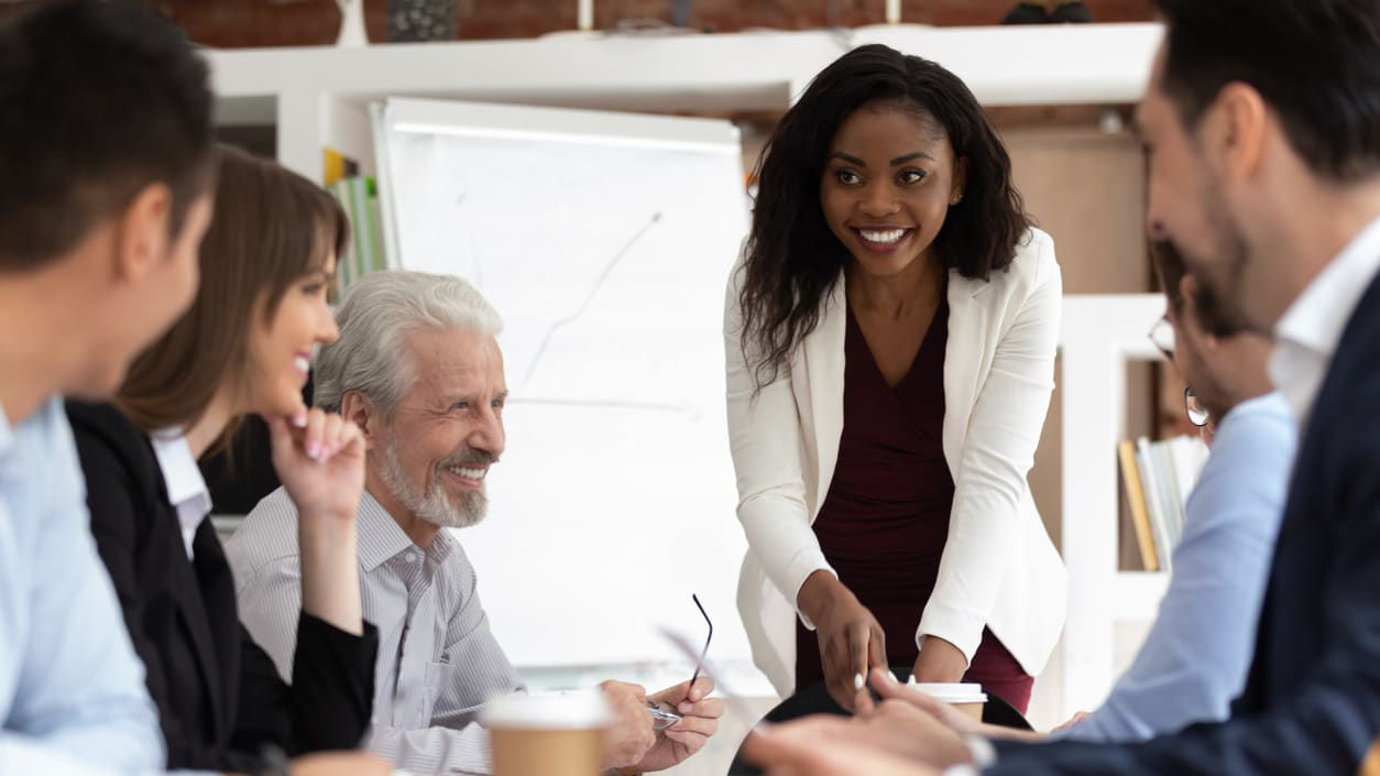 A group of business people sitting around a table.