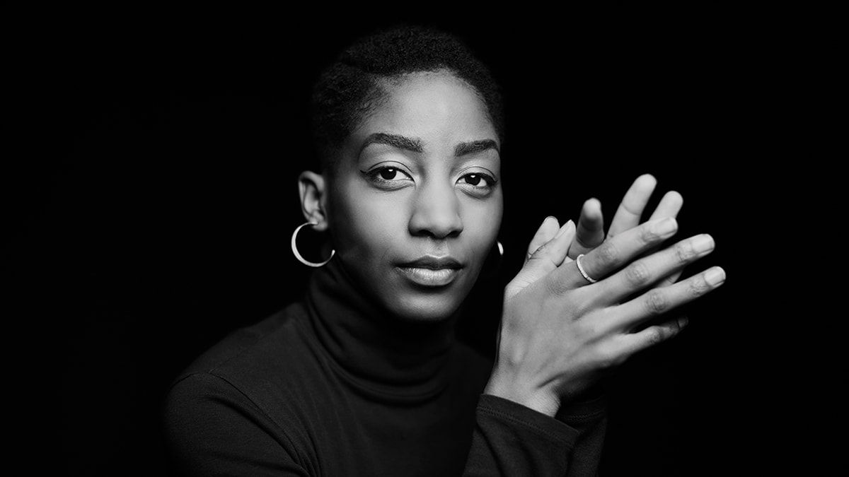 A black and white photo of a woman posing.