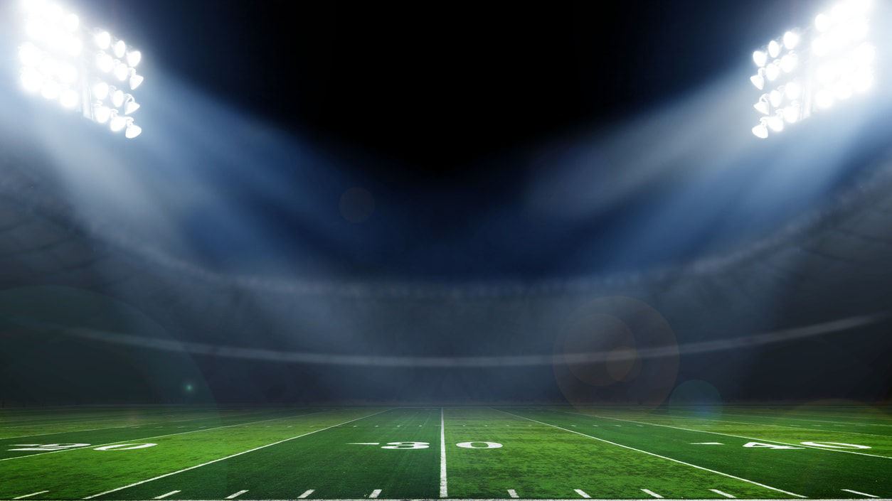 An empty football stadium with spotlights.