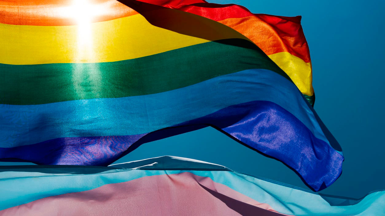 A rainbow flag waving in the wind.